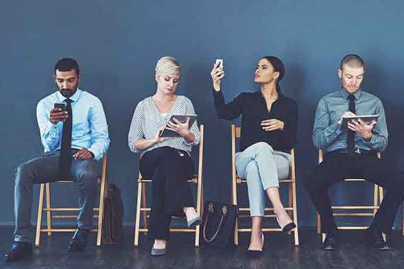 'four people sitting in office"
