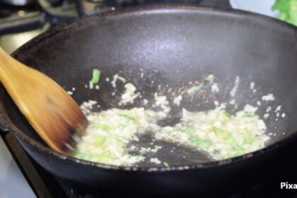 alt="cooking garlic and onions"