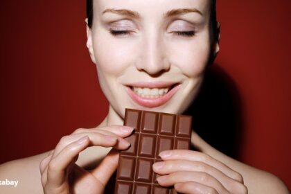 alt="woman eating dark chocolate"
