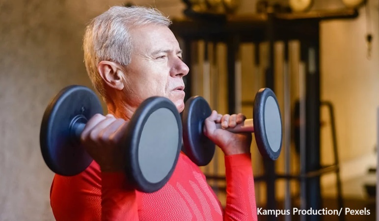 alt="old man weight training"