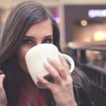alt="woman drinking coffee"