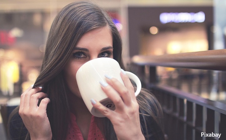 alt="woman drinking coffee"